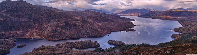 panoramic_view_of_a_mountain_lake-wallpaper-7108x1999|690x193